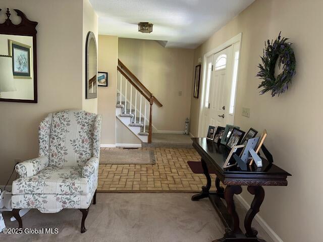 12 Bain Dr, Bethlehem, NY 12054 - entryway with stairs, carpet, and brick patterned flooring