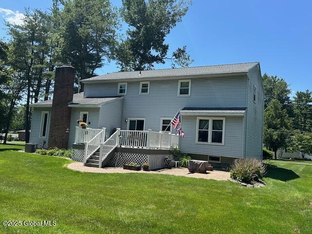 12 Bain Dr, Bethlehem, NY 12054 - back of house featuring a wooden deck, a yard, and a chimney