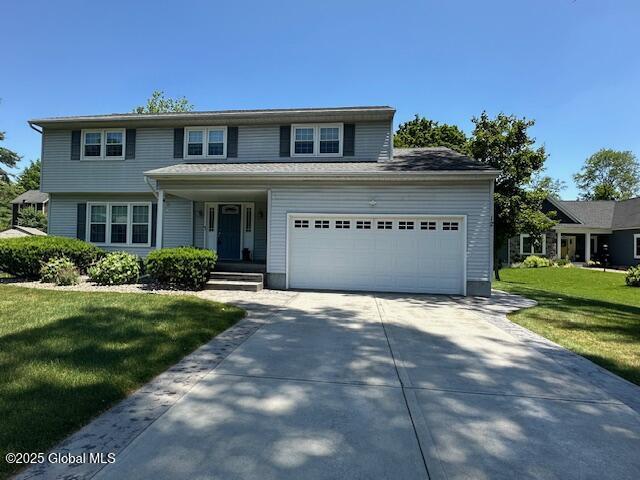 12 Bain Dr, Bethlehem, NY 12054 - traditional-style home featuring driveway, a front lawn, and an attached garage