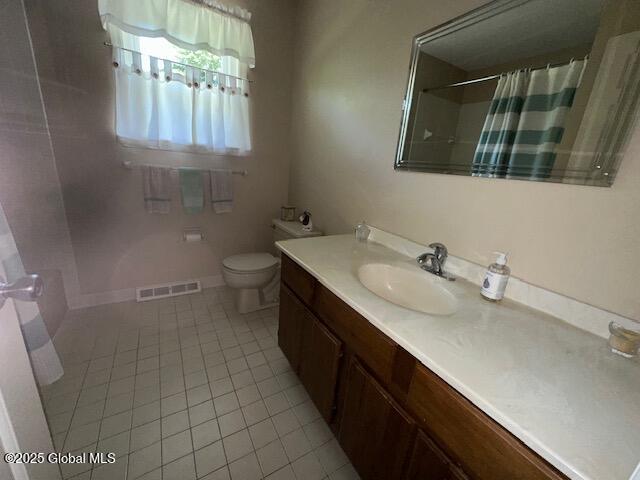 12 Bain Dr, Bethlehem, NY 12054 - full bath featuring tile patterned flooring, vanity, and a shower with curtain