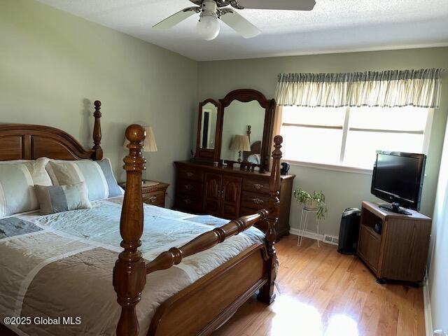 12 Bain Dr, Bethlehem, NY 12054 - bedroom with light wood-style flooring and a ceiling fan