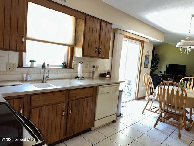 12 Bain Dr, Bethlehem, NY 12054 - kitchen featuring white dishwasher, healthy amount of natural light, and decorative backsplash