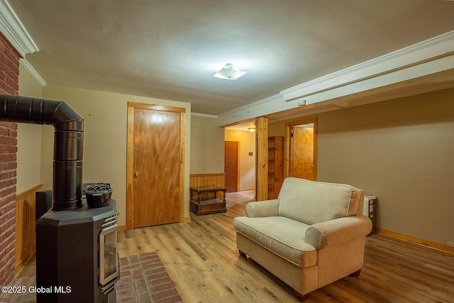 64 Coon Ln, Salem, NY 12865 - sitting room featuring a wood stove, light wood-style floors, ornamental molding, and wainscoting