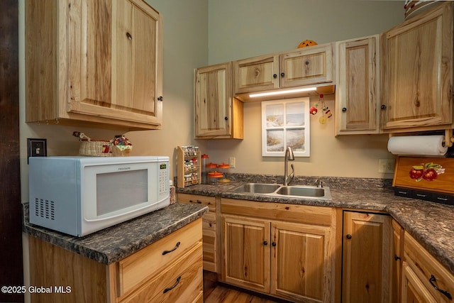 64 Coon Ln, Salem, NY 12865 - kitchen featuring white microwave, dark countertops, light brown cabinets, and wood finished floors