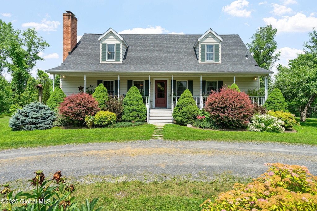 58 Van Deusen Rd, Hudson, NY 12534 - new england style home featuring a chimney, a porch, a shingled roof, and a front yard
