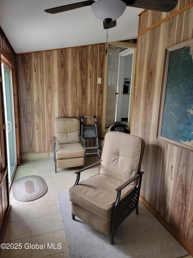 1045 Wallace Ave, Rotterdam, NY 12306 - living area featuring wooden walls, ceiling fan, and light tile patterned flooring
