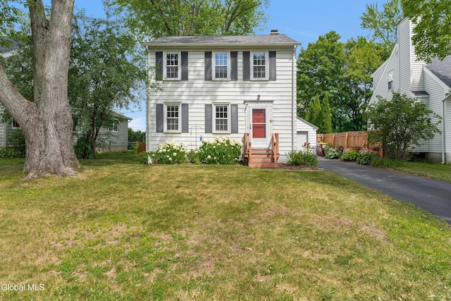 30 Crannell Ave, Bethlehem, NY 12054 - colonial-style house with entry steps, a garage, asphalt driveway, and a chimney