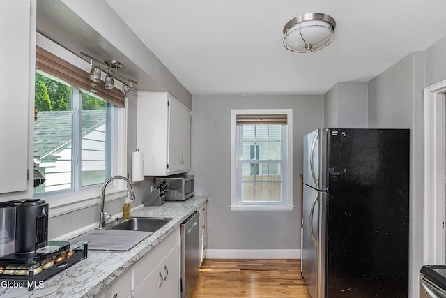 30 Crannell Ave, Bethlehem, NY 12054 - kitchen featuring stainless steel appliances, light wood finished floors, plenty of natural light, and white cabinetry