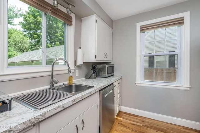 30 Crannell Ave, Bethlehem, NY 12054 - kitchen featuring appliances with stainless steel finishes, light wood finished floors, light countertops, and plenty of natural light
