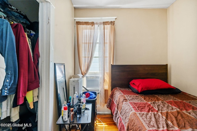 373 Delaware Ave, Albany, NY 12209 - bedroom featuring multiple windows, wood finished floors, and cooling unit