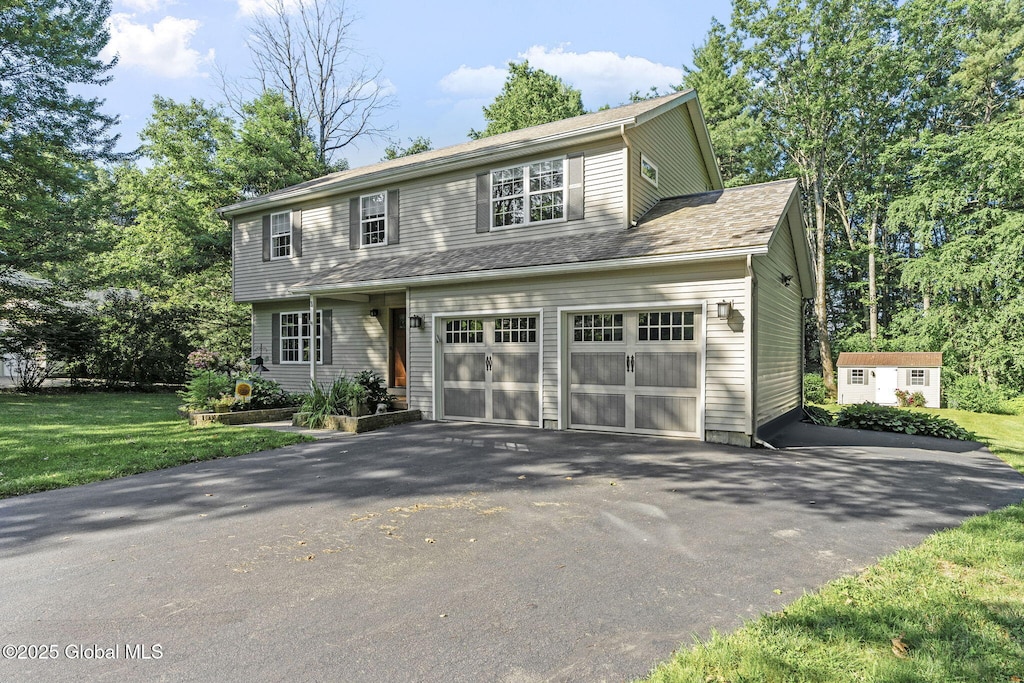 3 Pineridge Ct, Greenfield, NY 12833 - view of front of property with asphalt driveway, a shed, and a front yard