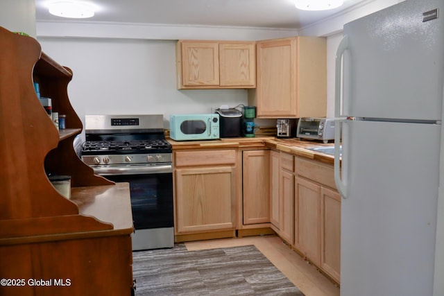 103 Seven Oaks Rd, Caroga, NY 12032 - kitchen with white appliances, light brown cabinets, and wooden counters