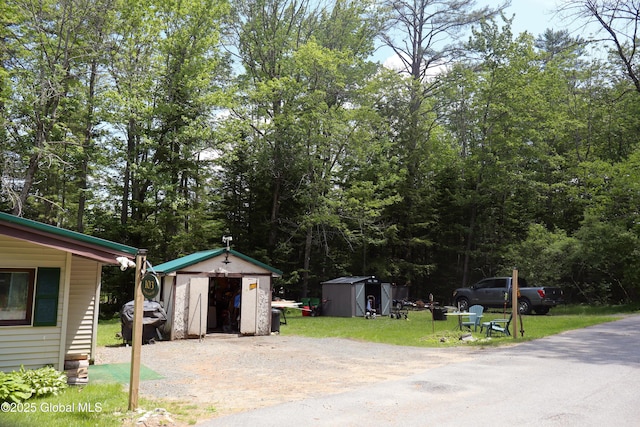 103 Seven Oaks Rd, Caroga, NY 12032 - view of green lawn featuring a storage shed