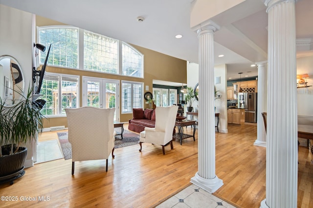 18 Beresford Rd, Clifton Park, NY 12019 - living room featuring ornate columns, light wood-style flooring, a high ceiling, and recessed lighting