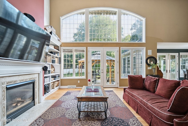 18 Beresford Rd, Clifton Park, NY 12019 - living area with french doors, a high ceiling, wood finished floors, and a fireplace