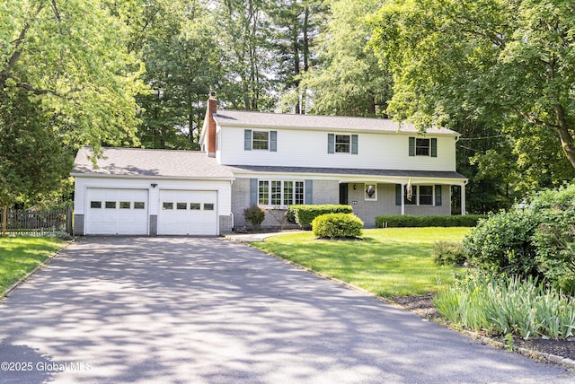 8 Burning Bush Blvd, Clifton Park, NY 12019 - traditional home with driveway, an attached garage, a chimney, and view of scattered trees