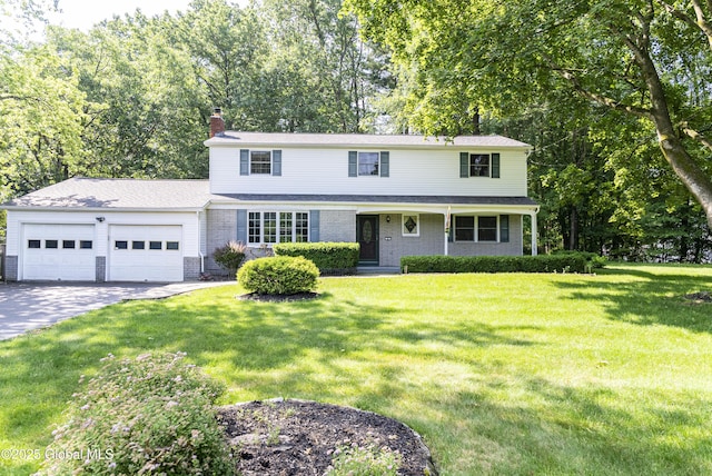 8 Burning Bush Blvd, Clifton Park, NY 12019 - traditional-style home featuring an attached garage, a chimney, driveway, a front lawn, and brick siding
