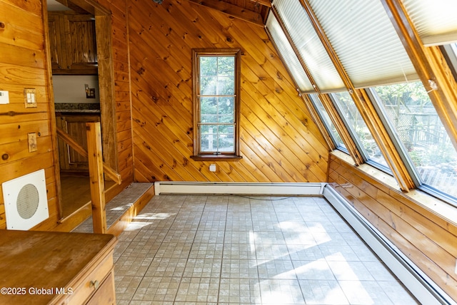 8 Burning Bush Blvd, Clifton Park, NY 12019 - interior space featuring a baseboard heating unit, healthy amount of natural light, wooden walls, and vaulted ceiling
