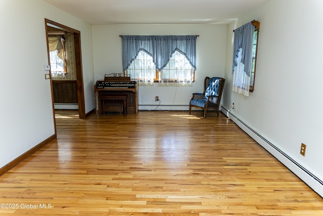 8 Burning Bush Blvd, Clifton Park, NY 12019 - living area with a baseboard radiator, light wood-style floors, and plenty of natural light