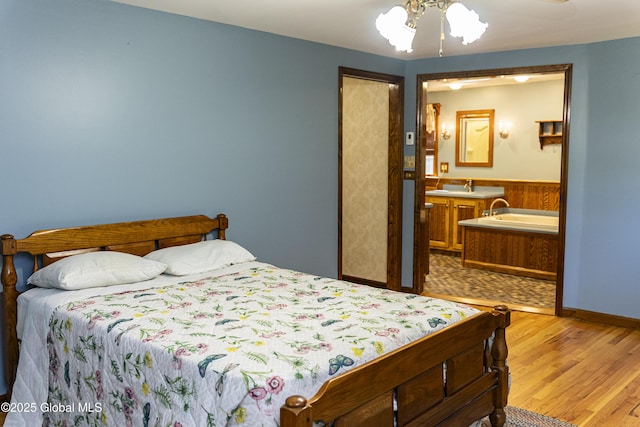 8 Burning Bush Blvd, Clifton Park, NY 12019 - bedroom featuring wood finished floors, wainscoting, and connected bathroom