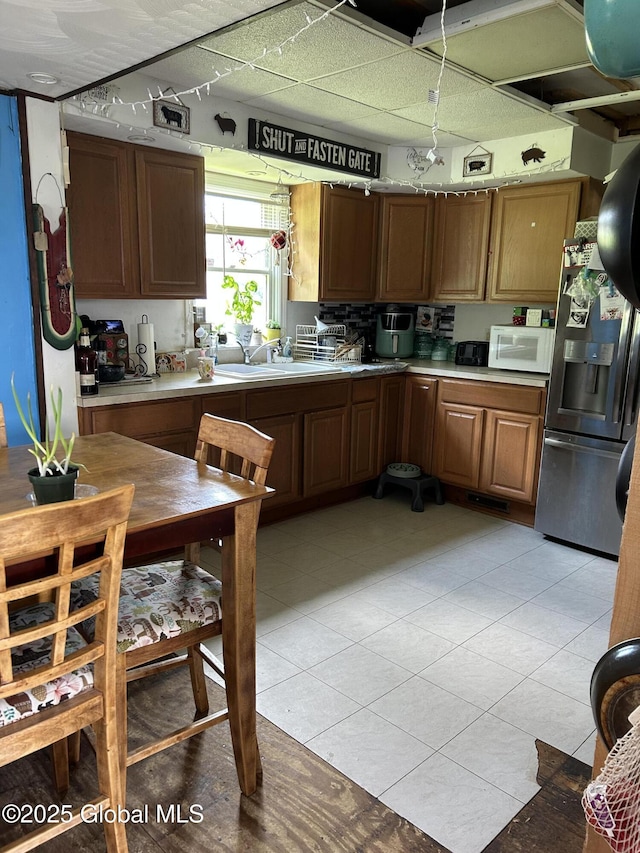 200 State Route 29a, Salisbury, NY 13454 - kitchen featuring stainless steel fridge, light countertops, white microwave, and light tile patterned floors