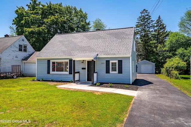 2095 Fiero Ave, Rotterdam, NY 12303 - cape cod-style house featuring a detached garage, asphalt driveway, a shingled roof, a front lawn, and an outdoor structure