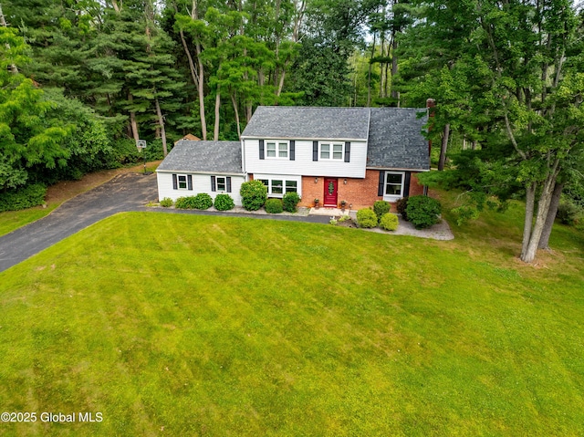 973 Avon Crest Blvd, Niskayuna, NY 12309 - view of front of home with driveway, a front lawn, brick siding, and view of scattered trees