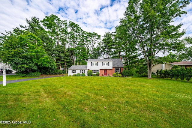 973 Avon Crest Blvd, Niskayuna, NY 12309 - colonial house with a front lawn, driveway, and brick siding