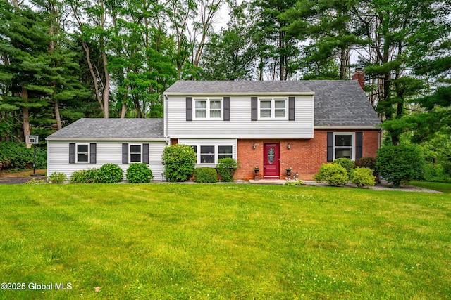 973 Avon Crest Blvd, Niskayuna, NY 12309 - view of front facade with a chimney, a front lawn, brick siding, and roof with shingles
