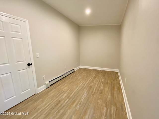 3 Olcott Ln, East Greenbush, NY 12144 - spare room featuring a baseboard radiator and wood finished floors