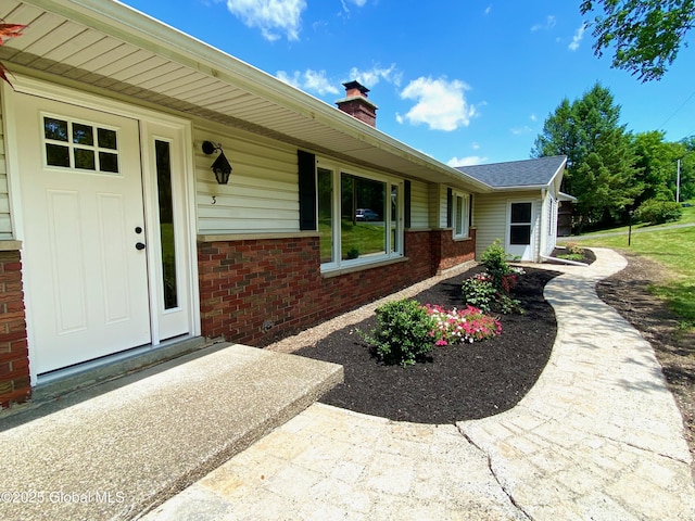 3 Olcott Ln, East Greenbush, NY 12144 - property entrance featuring brick siding and a chimney