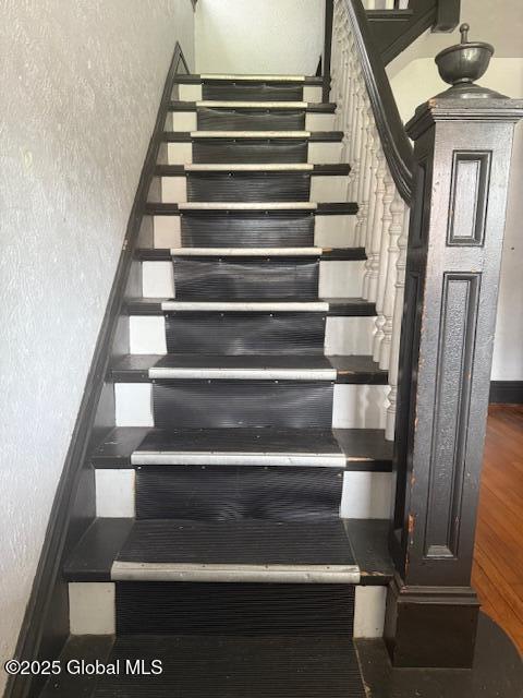 527 Pawling Ave, Troy, NY 12180 - stairway with a textured wall and wood finished floors