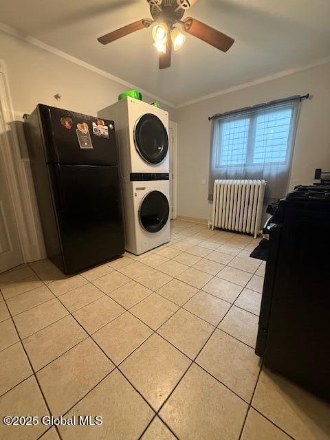527 Pawling Ave, Troy, NY 12180 - laundry area with radiator, stacked washer and clothes dryer, ornamental molding, light tile patterned flooring, and a ceiling fan