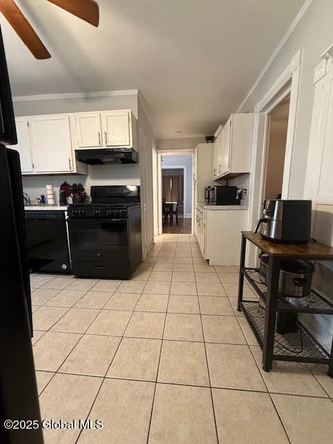 527 Pawling Ave, Troy, NY 12180 - kitchen featuring black appliances, under cabinet range hood, white cabinetry, and light tile patterned floors