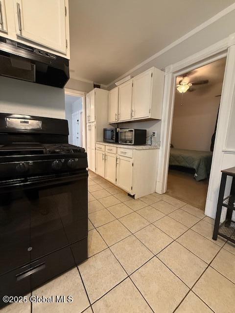 527 Pawling Ave, Troy, NY 12180 - kitchen with black appliances, white cabinets, light tile patterned floors, ventilation hood, and light countertops