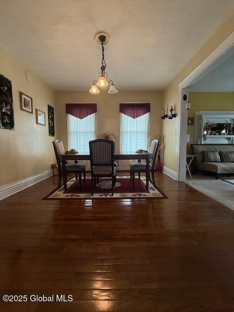 527 Pawling Ave, Troy, NY 12180 - dining space with a chandelier and dark wood finished floors