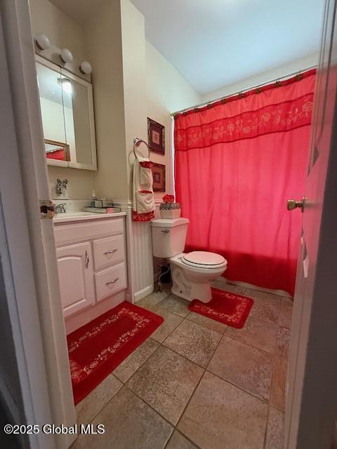 527 Pawling Ave, Troy, NY 12180 - full bathroom featuring vanity, a shower with shower curtain, tile patterned floors, and vaulted ceiling
