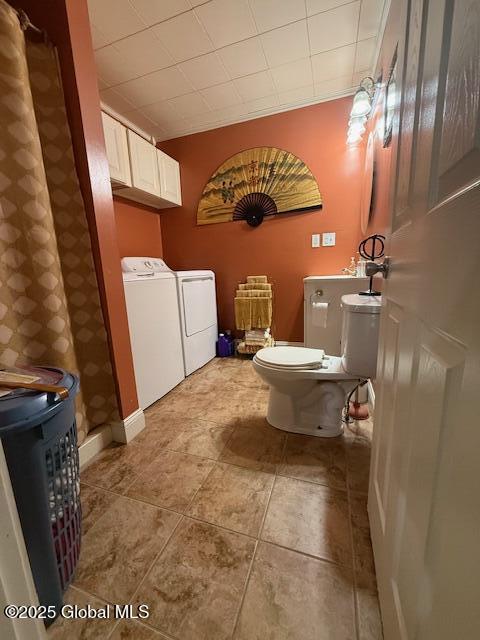 527 Pawling Ave, Troy, NY 12180 - bathroom with washing machine and dryer and tile patterned flooring