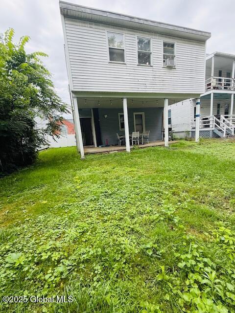 527 Pawling Ave, Troy, NY 12180 - rear view of house featuring a patio area, a yard, and cooling unit