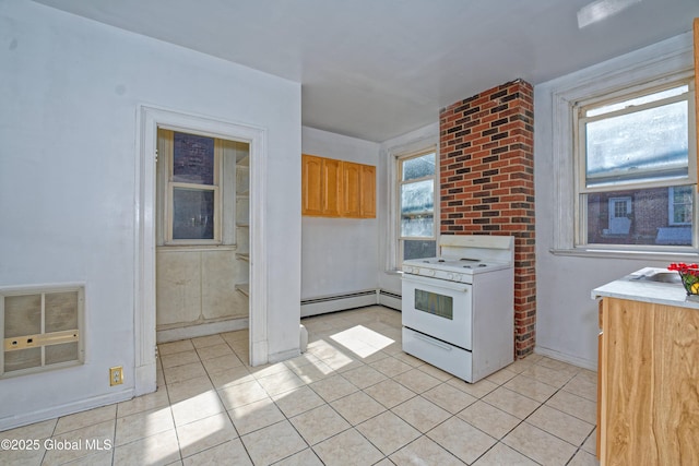 850 Peoples Ave, Troy, NY 12180 - kitchen with white range with gas stovetop, a baseboard heating unit, light tile patterned floors, and light countertops