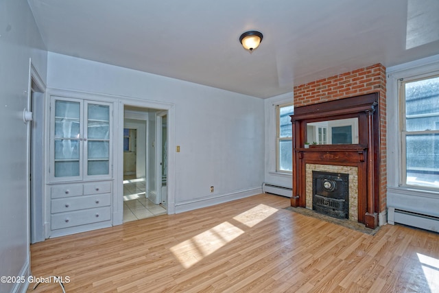 850 Peoples Ave, Troy, NY 12180 - unfurnished living room featuring light wood-type flooring, a baseboard heating unit, and a fireplace