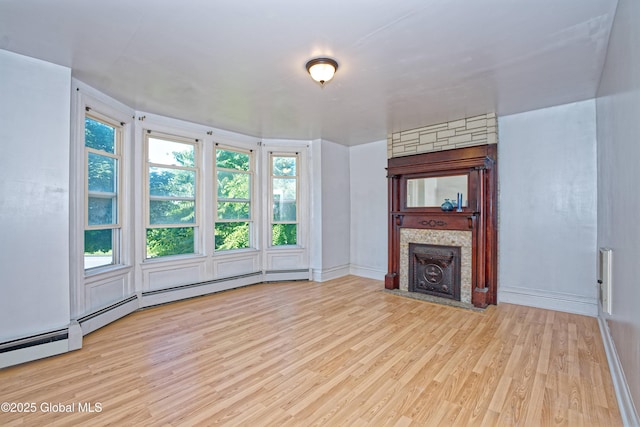 850 Peoples Ave, Troy, NY 12180 - unfurnished living room with wood finished floors, healthy amount of natural light, and a fireplace