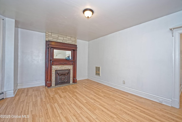 850 Peoples Ave, Troy, NY 12180 - unfurnished living room with wood finished floors, a fireplace, and heating unit