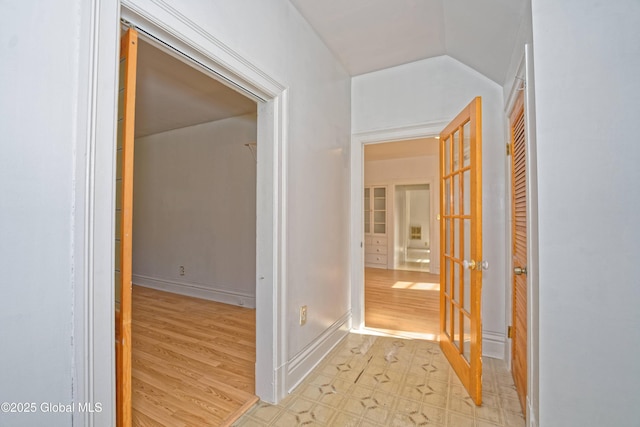 850 Peoples Ave, Troy, NY 12180 - hallway featuring french doors, vaulted ceiling, and light wood-style floors