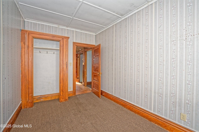 850 Peoples Ave, Troy, NY 12180 - unfurnished bedroom with wallpapered walls, carpet, crown molding, and a closet