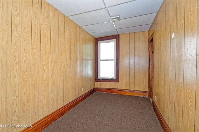 850 Peoples Ave, Troy, NY 12180 - spare room featuring dark colored carpet, wood walls, and a paneled ceiling