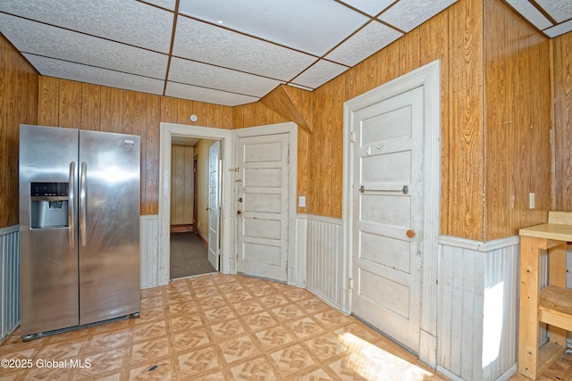 850 Peoples Ave, Troy, NY 12180 - kitchen featuring stainless steel refrigerator with ice dispenser, wood walls, and a wainscoted wall