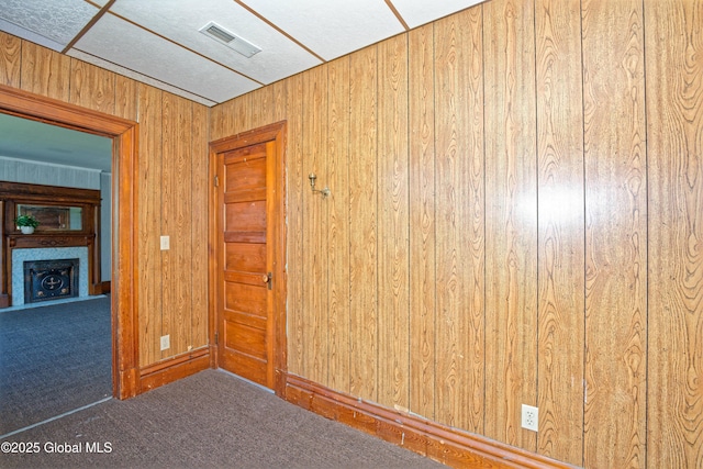 850 Peoples Ave, Troy, NY 12180 - empty room with carpet flooring, a fireplace, and wood walls