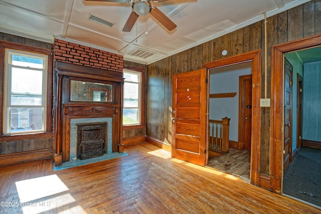 850 Peoples Ave, Troy, NY 12180 - unfurnished living room with ceiling fan, wooden walls, healthy amount of natural light, a large fireplace, and wood finished floors
