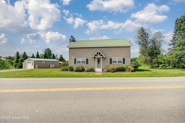 1330 State Highway 67, Johnstown, NY 12095 - traditional-style house with a chimney, a metal roof, a detached garage, and asphalt driveway